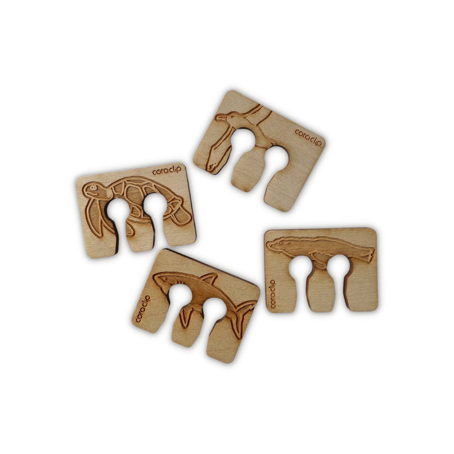 Wooden bag clip Collection A, clockwise from top: Albatross, Seal, Shark, and Sea Turtle designs.