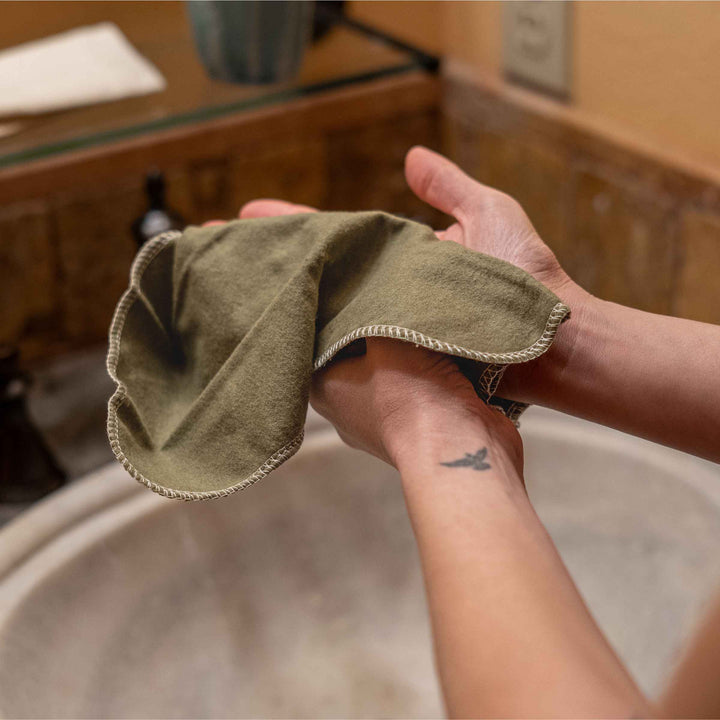 Non-paper towel shown in hands for cleanup while traveling.