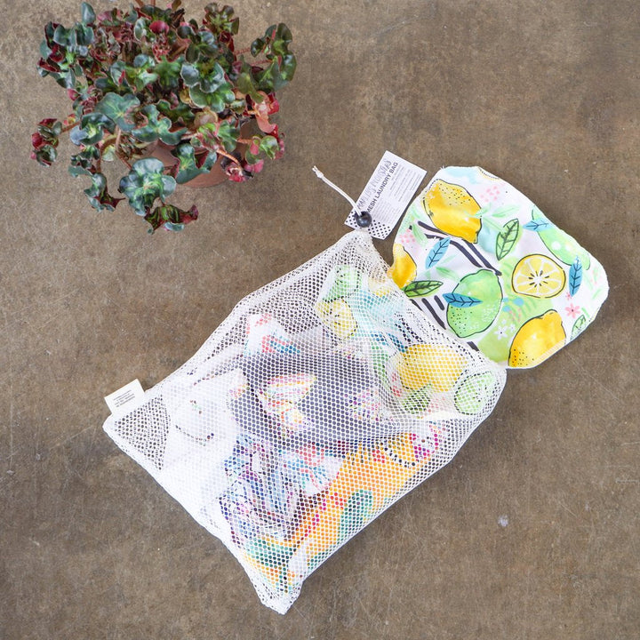 Marleys Monsters Large Mesh Laundry Bag Filled With Laundry Items. Shown Here With A Plant.
