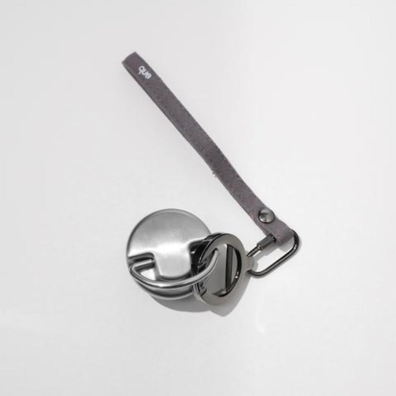 Que Bottle Stainless steel bottle cap with loop and gray wrist strap with keyring and bottle opener.