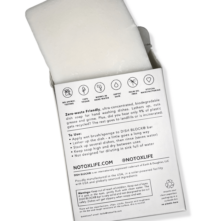 No Tox Life vegan dish block solid dish washing soap partially removed from eco friendly cardboard box.