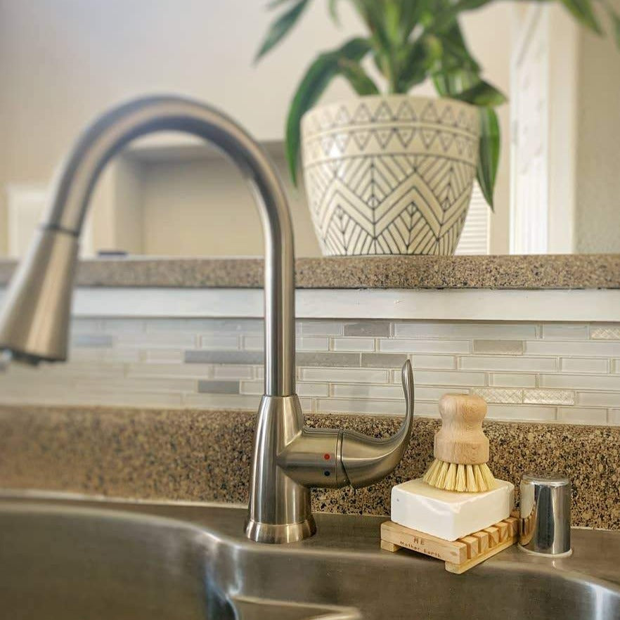 ME Mother Earth Sisal Plastic Free Kitchen Dish Washing Brush, Shown At Sink, Atop Dish Washing Block And Wood Soap Dish.