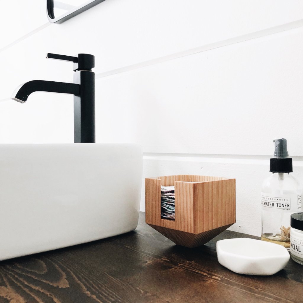 Marleys Monsters Wooden Facial Rounds Dispenser On Bathroom Counter.