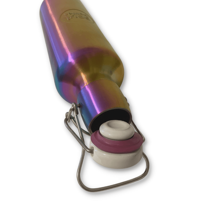 Soulbottles Utopia Stainless Steel Water Bottle - 20 ounce. Rainbow Colored and Plastic Free. Opened Bottle Showing Ceramic Top, Natural Rubber Seal, and Stainless Steel Hinge Fastener, Preventing Leakage.